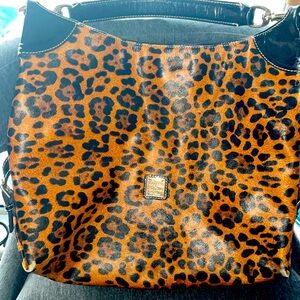 Dooney&Burke well loved satchel. Hand strap black patten leather sides